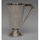 An Art Deco silver conical mug, quite plain, angular scroll handle, moulded circular foot,