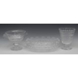 A large Waterford crystal oval bowl, wavy fan shaped rim, above strawberry cut hobnails,