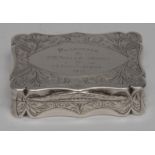 A George V silver shaped rectangular snuff box, bright-cut engraved with scrolling foliage,