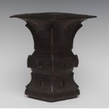 A Chinese bronze lozenge shaped vase, cast in the Archaic taste with fretwork and scrolls,