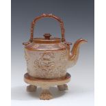 A mid 19th century brown salt glazed stoneware tea kettle,