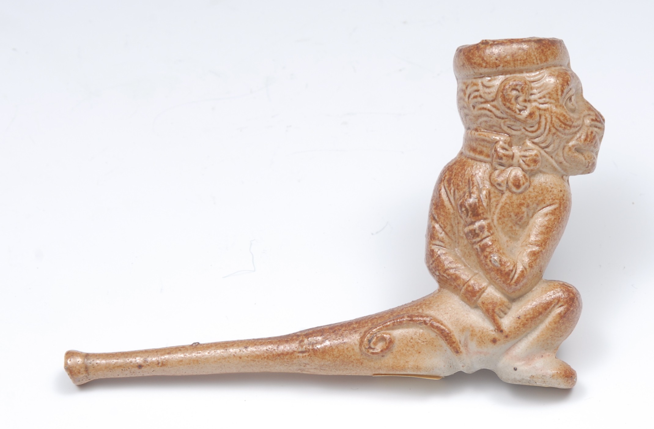 A 19th century brown salt glazed caricature pipe, the bowl in relief with a monkey, 12cm long, c.