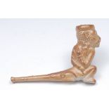 A 19th century brown salt glazed caricature pipe, the bowl in relief with a monkey, 12cm long, c.