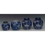 A pair of Chinese ginger jars and covers, decorated with blossoming prunus branches, 17cm high,