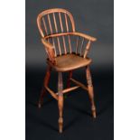 A 19th century elm and ash Windsor child's high chair, hooped back, curved arm rail, saddle seat,