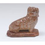 A Brampton brown salt glazed stoneware model of a spaniel, seated facing to the left,