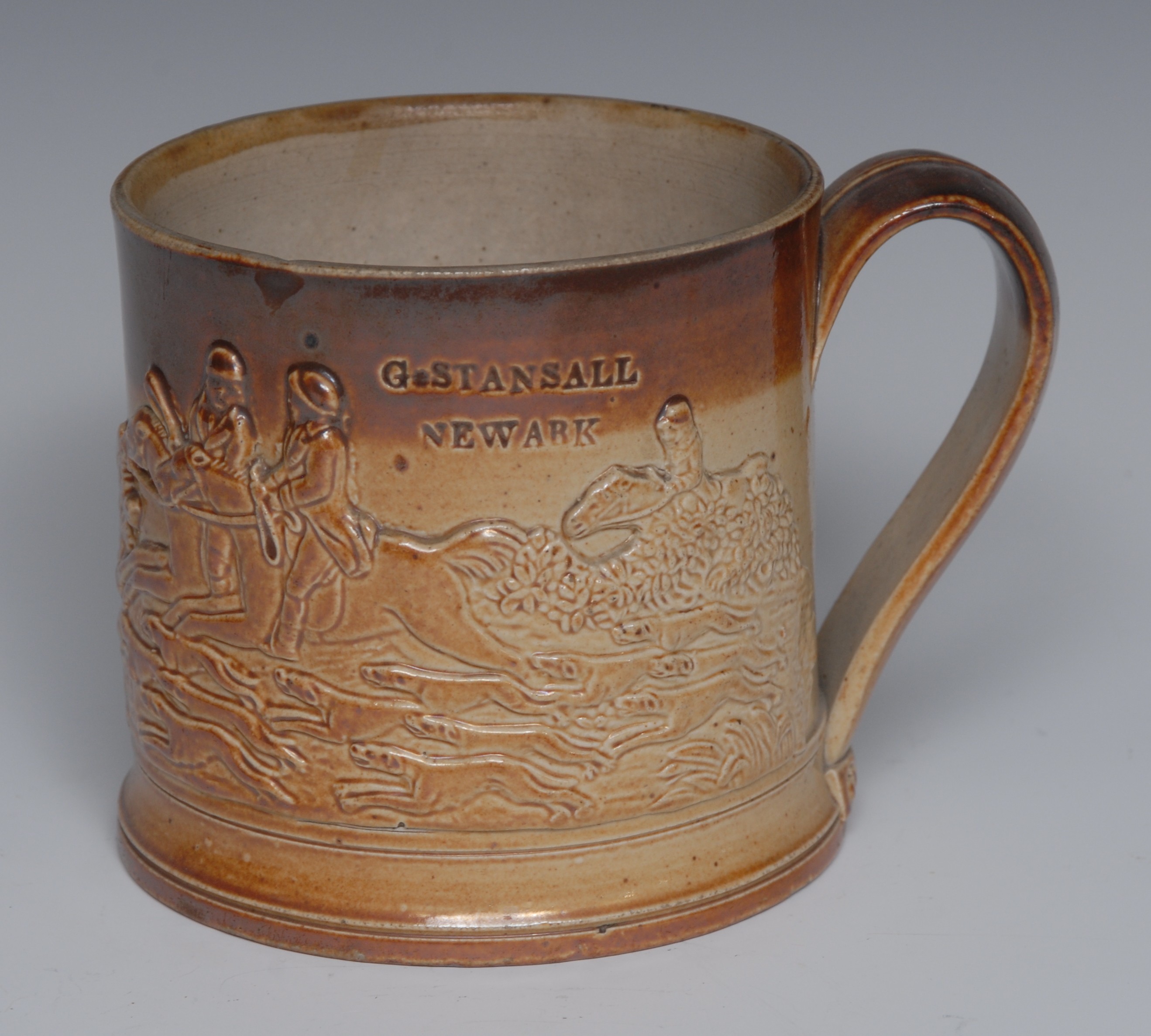 A 19th century Chesterfield brown salt glaze stoneware mug, in relief with huntsman, hounds and fox,