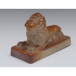 A Brampton brown salt glazed stoneware model of a recumbent lion, rectangular base, 19cm wide,