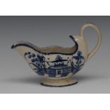 A Staffordshire Pearlware sauce boat, decorated in underglaze blue with stylised pagoda and fence,