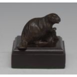 An early 20th century patinated bronze desk weight, as a beaver, square mahogany base,