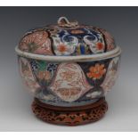 A Chinese circular jar or tureen and cover, painted in the Imari palette with stylised flowers,