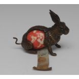 A 19t century novelty bronzed tape measure holder, in the form of a hare, green glass eyes,