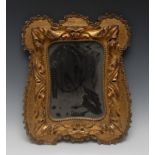 A 19th century giltwood and gesso shaped rectangular looking glass, bold acanthus border,