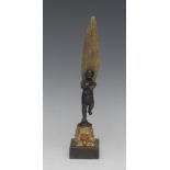 French School, a dark patinated and parcel-gilt cabinet bronze, of a winged putto,