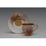 A Royal Worcester cabinet cup and saucer, painted by Jas Stinton, signed, with pheasants,