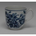 A Worcester Three Flowers pattern coffee cup, decorated in underglaze blue, 6cm high, crescent mark,