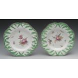 A pair of Longton Hall shaped circular leaf moulded plates, painted with colourful summer flowers,