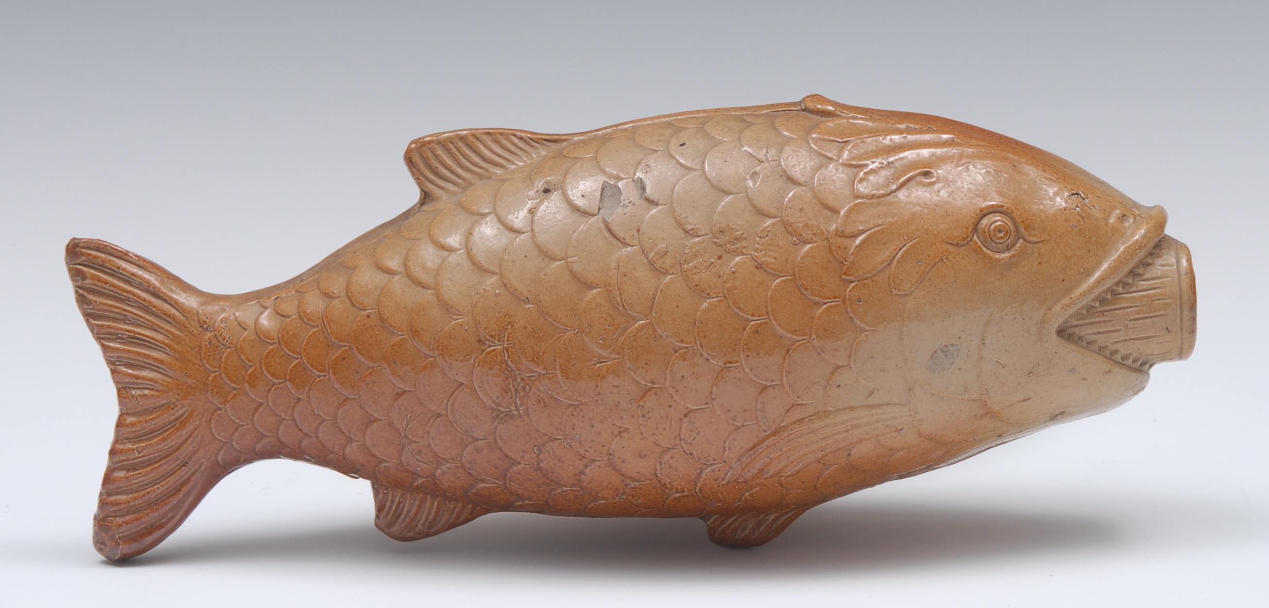 A Brampton brown salt glazed stoneware novelty flask, in the form of a fish, 24cm long,