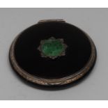 An Art Deco jade mounted silver and noir enamel circular powder compact,