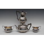 A late Victorian/Edwardian silver half-fluted boat shaped tea service, comprising tea pot,