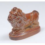 A Brampton brown salt glazed stoneware model of a recumbent lion, oval base, 7cm wide,