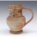 A 19th century brown salt glazed stoneware puzzle jug, pierced with hearts and geometric motifs,