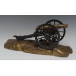 An interesting gilt metal and hardwood model field cannon, the 20cm barrel with crowned GR cipher,