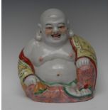 A Chinese figure, of the rotund Budai, seated, smiling, impressed marks, 23cm high,