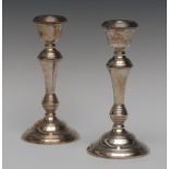 A pair of Elizabeth II silver candlesticks, bell shaped sconces, knopped tapered stems,