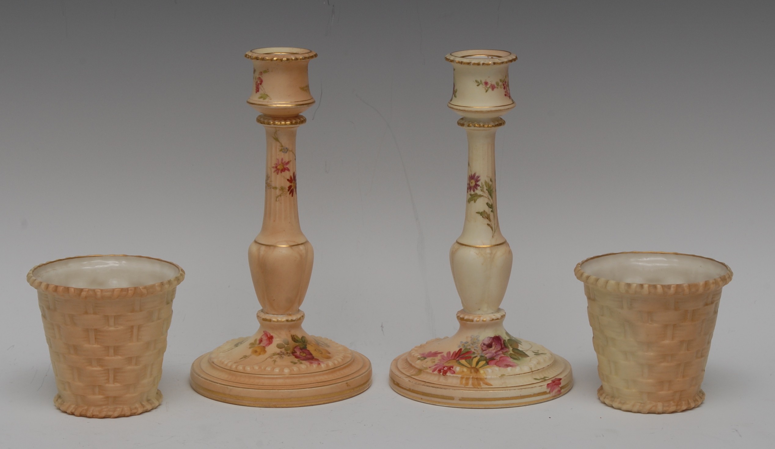 A pair of Royal Worcester blush Ivory candlesticks, reel sconces, fluted nad knopped column,