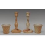 A pair of Royal Worcester blush Ivory candlesticks, reel sconces, fluted nad knopped column,