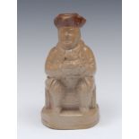 A 19th century brown salt glazed stoneware figural flask, of a rotund gentleman seated on a barrel,