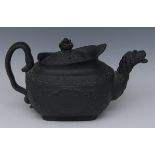 An English black basalt commemorative teapot and cover, one side moulded with Wellington,