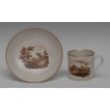 A Pinxton coffee cup and saucer, painted in sepia with cottage in landscape and a rocky outcrop,