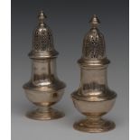 A pair of silver sugar casters, in George III style, lofty pierced covers, 16cm high,