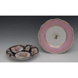 A Coalport dished plate, painted in the manner of William Billingsley,