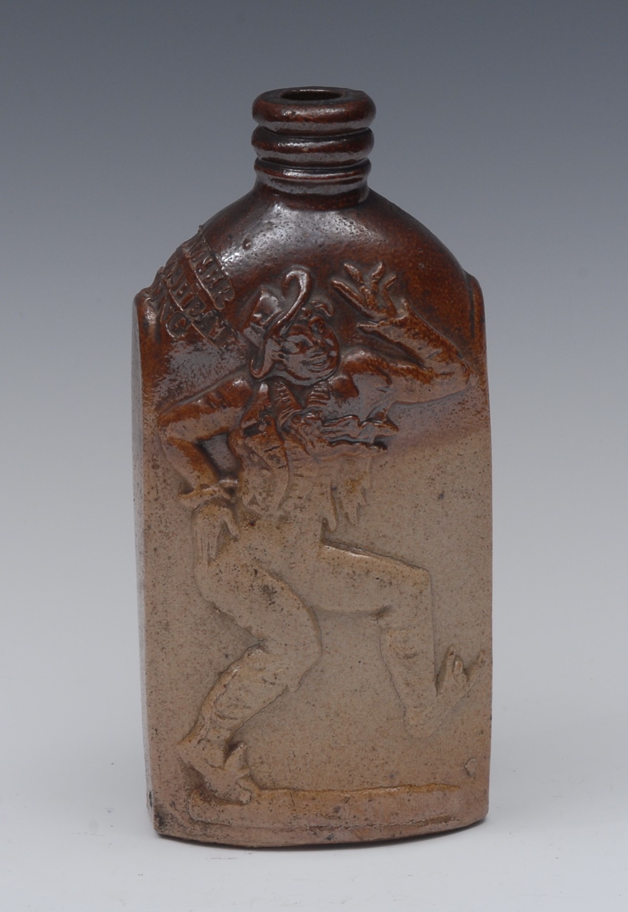 A 19th century brown salt glazed stoneware flask, moulded in relief comical man,