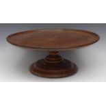 A 19th century mahogany lazy Susan, circular top with shallow border, turned column and base,