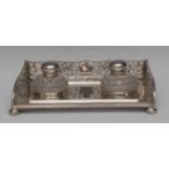 A large Edwardian silver rectangular inkstand, shaped and pierced three-quarter gallery,