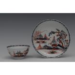 A Liverpool Cannonball pattern tea bowl and saucer, in underglaze blue and clobbered in red,