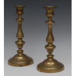 A pair of 18th century brass candlesticks, of seamed construction, beaded detachable nozzles,