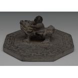 A Chinese stone octagonal Daoist tablet, carved with a figure riding a temple lion,