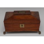 A Regency rosewood sarcophagus workbox, hinged cover inlaid with a shaped cartouche,