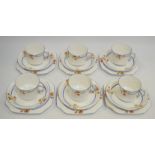 Carlton china part tea service decorated with a blue band and orange floral sprigs.