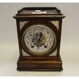 An early 20th Century oak mantel time piece,