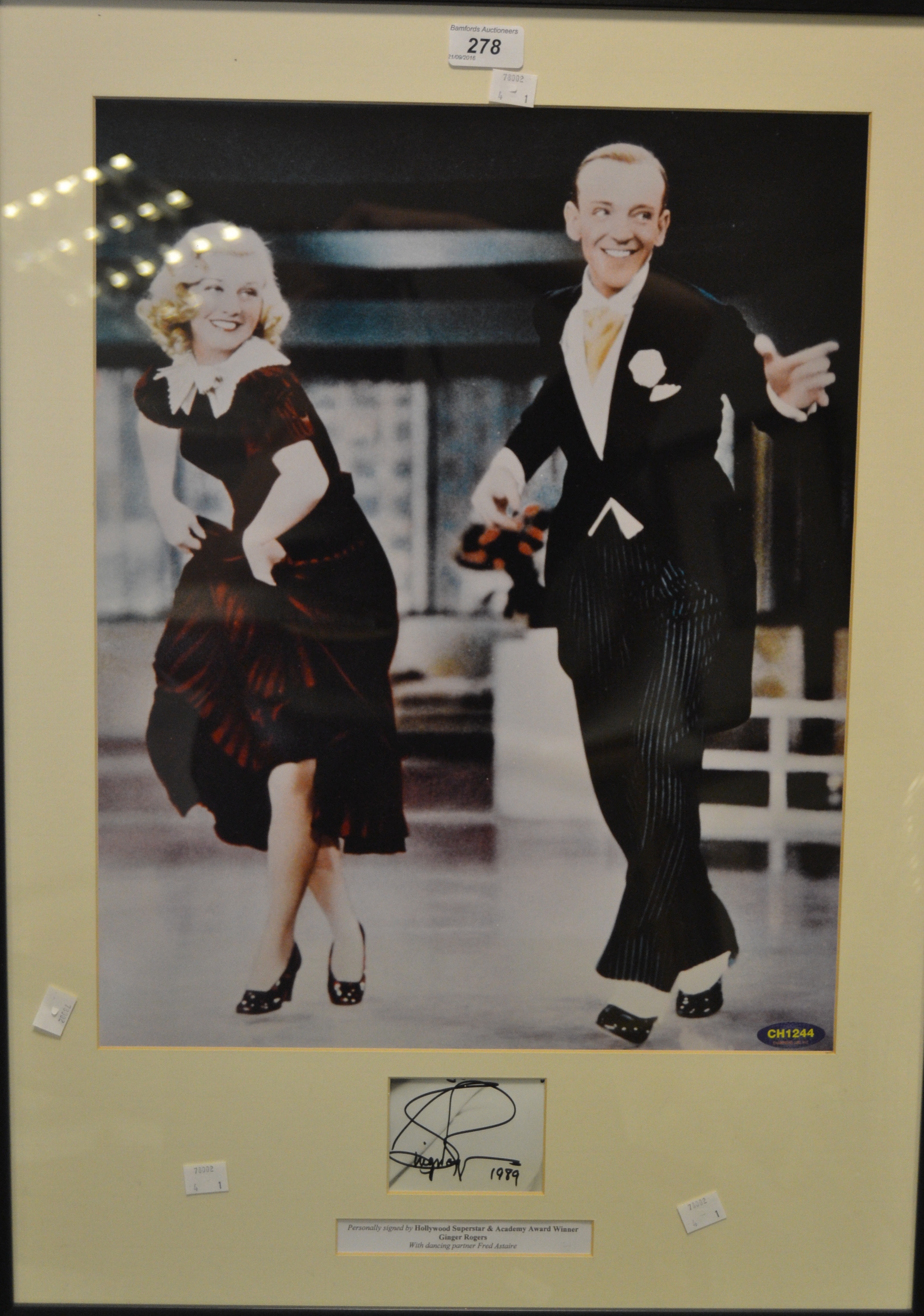 Autographs - a signed print of Ginger Rogers dancing alongside Fred Astaire, framed, dated 1989.