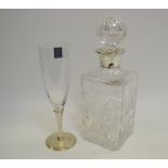 A glass decanter fixed with a silver collar,