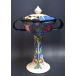 A Moorcroft trial-piece two-handled flared vase, tube lined with further flowers,