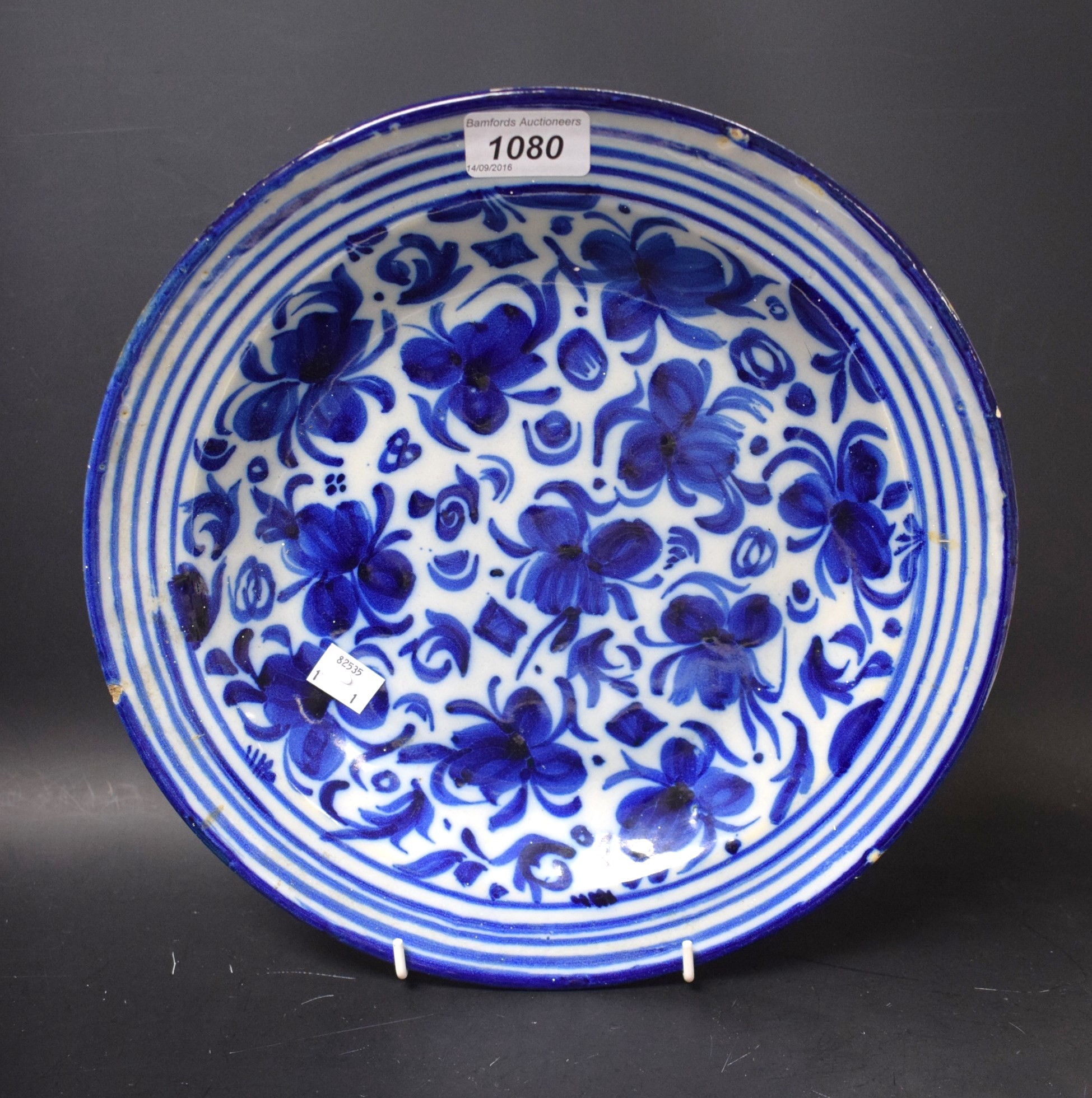 An 19th century South European blue and white tin glazed circular charger