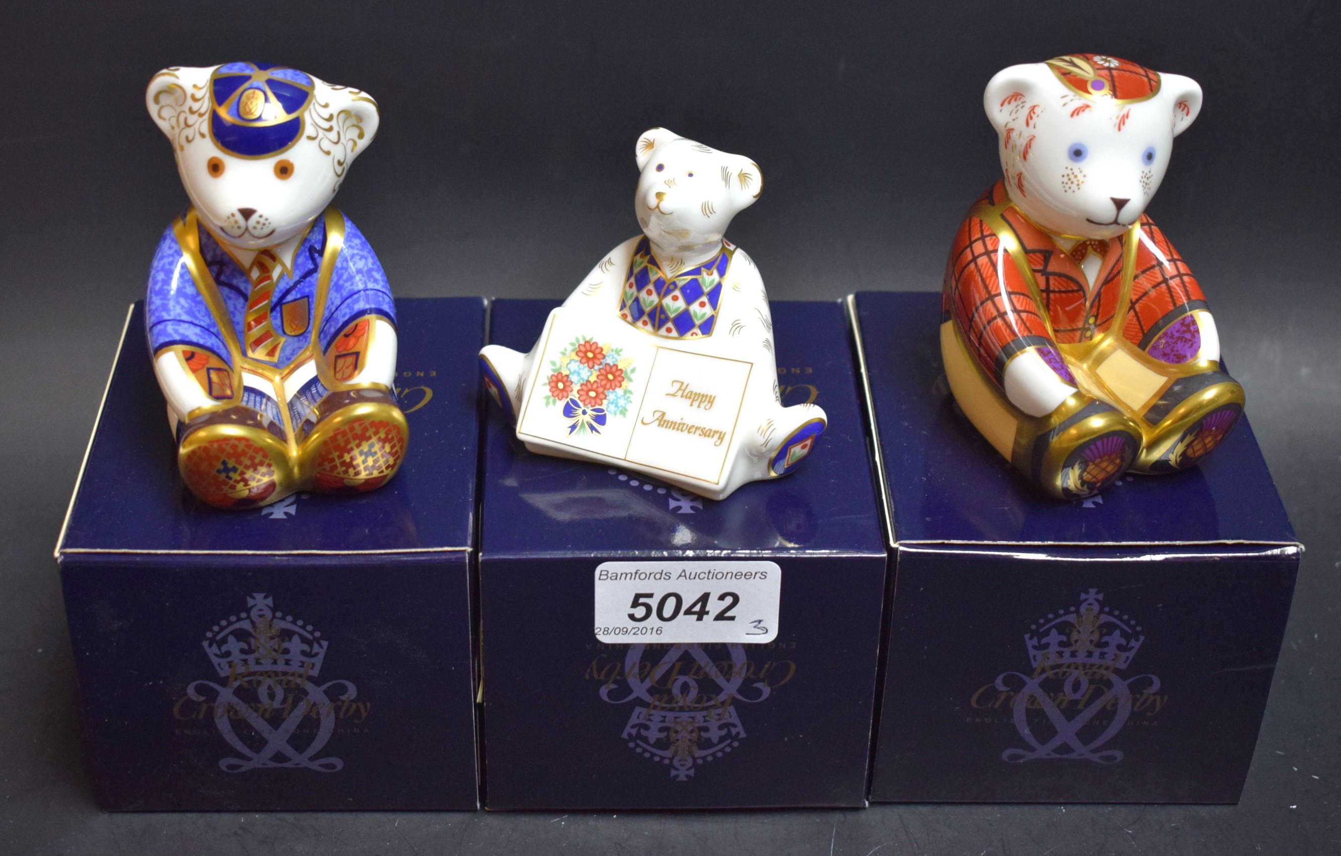 A Royal Crown Derby paperweight, Scottish Fraser Bear; others, Schoolboy Teddy; Happy Anniversary,